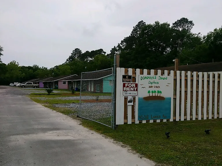 Property entrance with 5 acres with one single family residences and 5 duplexes with abundant space for parking and outdoor activity.