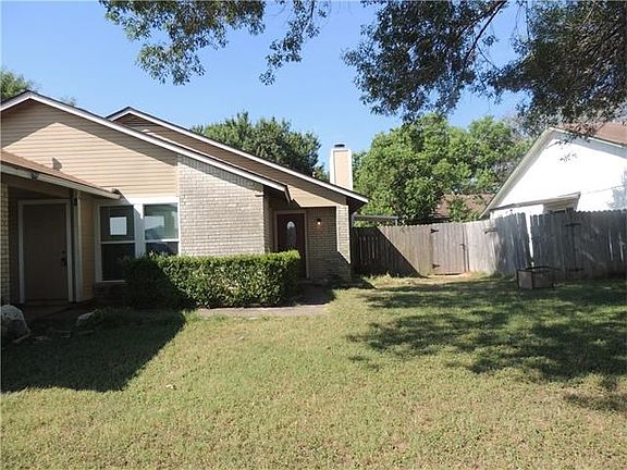 Large front lawn with shade tree + carport