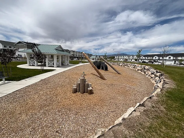 Playground in green space in front of house