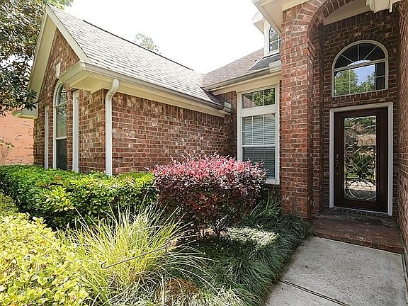 Leaded glass front door with covered porch welcomes all who arrive.