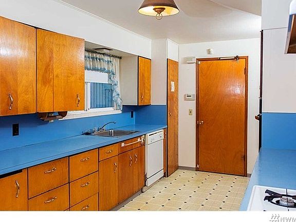 Kitchen off the garage with gas stove and kitchenette