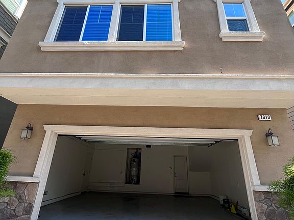 Back of house with 2-car garage