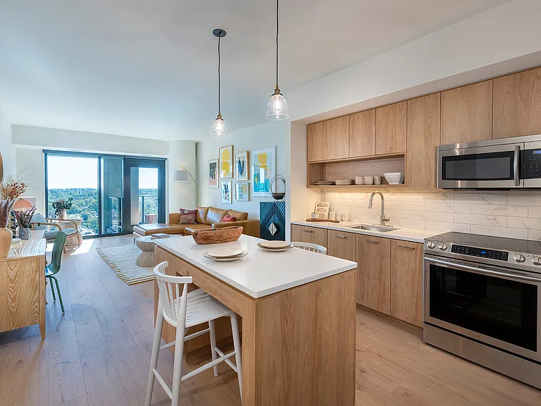 Modern gourmet kitchen with warm, natural finishes and high-end appliances