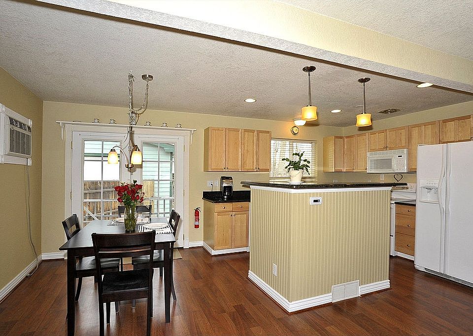 Updating living space with recessed lighting and a cook's island.