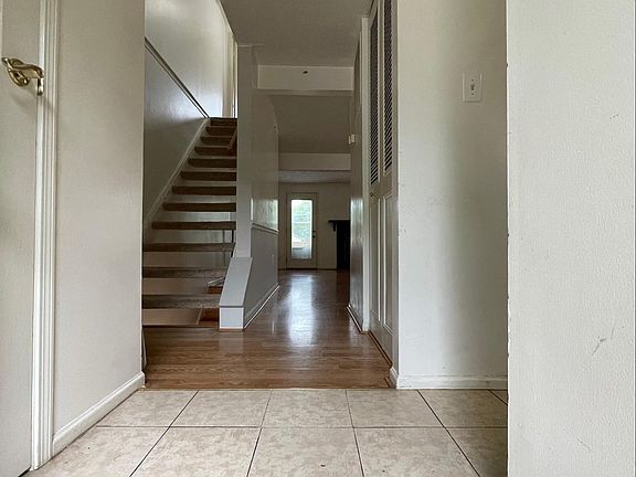 First floor hallway (left to powder room, right to kitchen area)