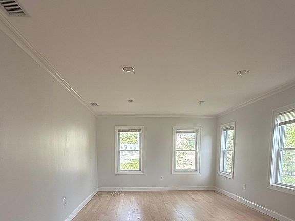 Freshly painted and refinished floors in large bright Living Room