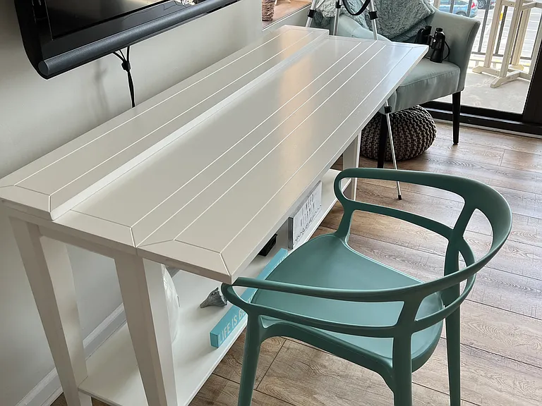 Sofa table under tv can be pulled out and turned into a dining table.