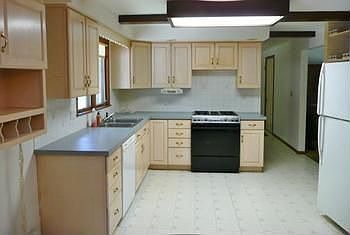 Light and airy kitchen is open to the family room and has plenty of light wood cabinets!
