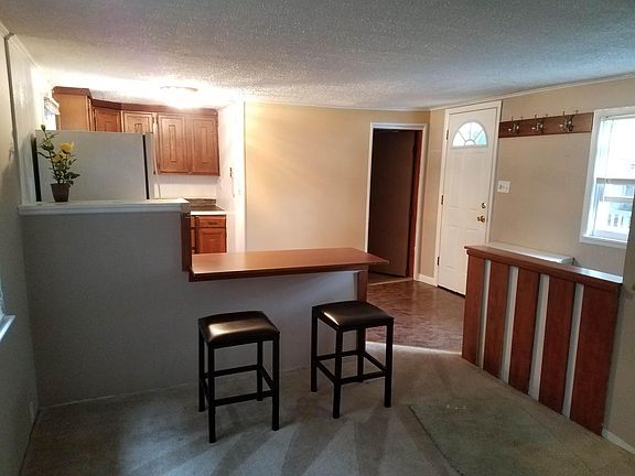 view from living room to kitchen, door on right is to bathroom