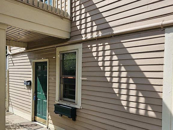 Private entrance for Unit 1B adjacent to the parking area (back of building).