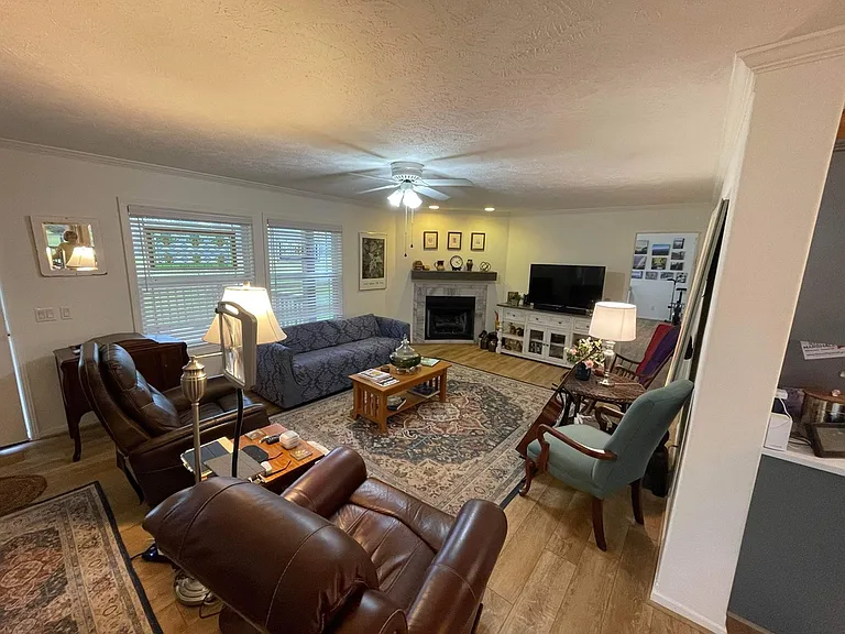 Living area view from eat in kitchen. Gas fireplace.