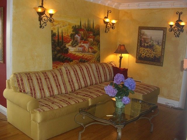 Beautiful living room with crown molding, woodburning fireplace, hardwood floors. Walls are all painted WHITE!