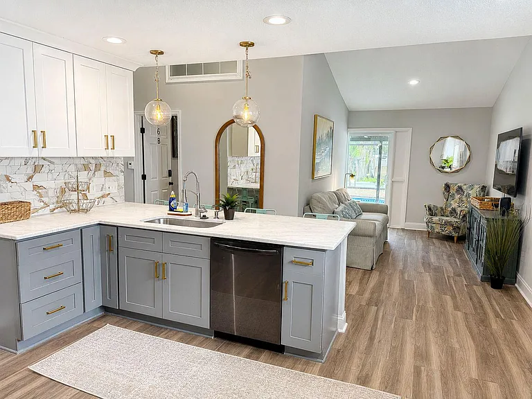 Open-concept kitchen with oversized island, ample cabinetry, and direct sightlines to the living area for easy hosting.