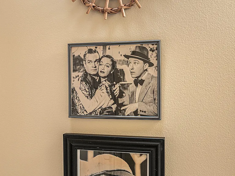 A curated wall of actor and actress photos adds personality and charm, giving the space a stylish, gallery-like feel.