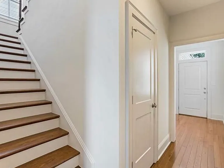 Foyer, downstairs hallway, half bath, and stairway