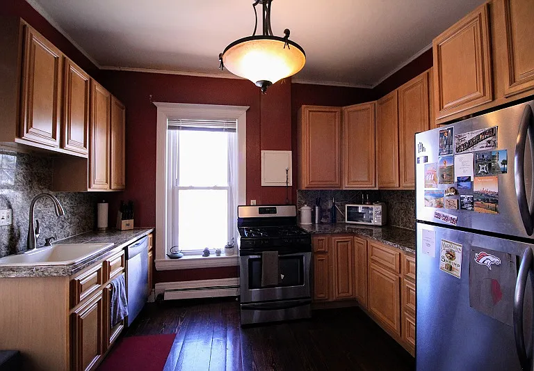Kitchen with ample storage, gas range, dishwasher, and refrigerator.