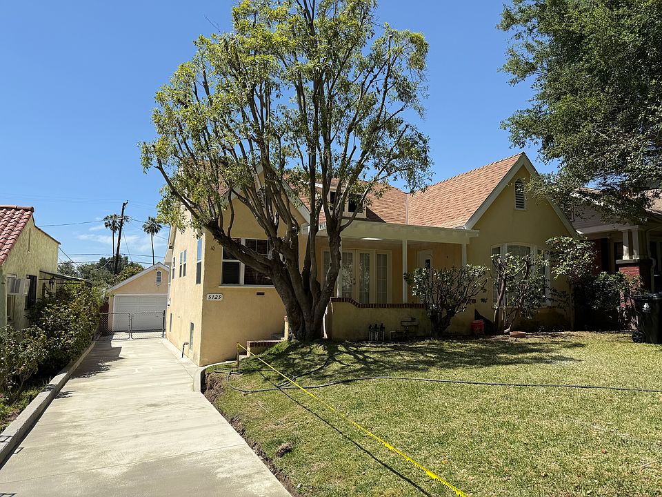 House with covered front porch and new driveway.