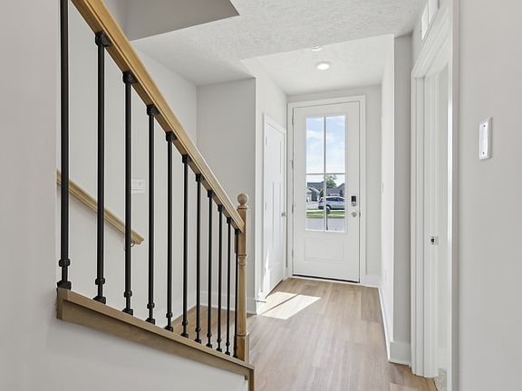 Main entry foyer with Staircase leading to Living Floor.
Foyer has access to Fourth Bedroom and Bathroom, Two Car Garage