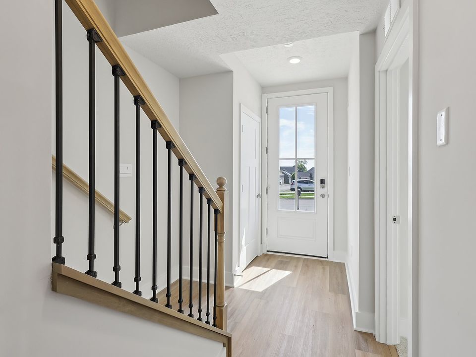 Main entry foyer with Staircase leading to Living Floor.
Foyer has access to Fourth Bedroom and Bathroom, Two Car Garage