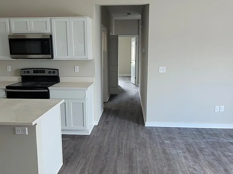 Hallway to bedrooms, bathroom, linen closet, and laundry