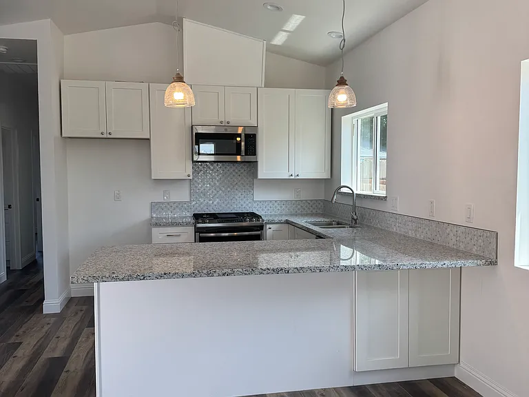 Kitchen with slow-close cabinets, granite top, stainless steel appliances (tennant must provide refrigerator).