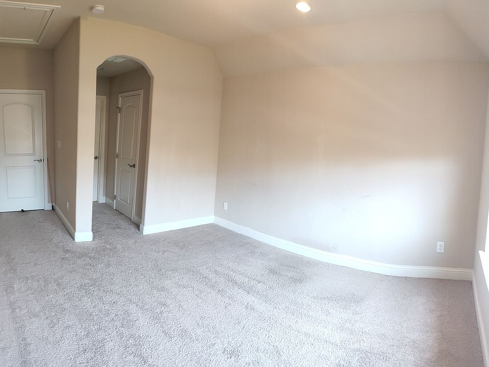 Suite 2 (Upstairs Left): Entrance into bedroom area. Looking towards closet (rightmost door) and private bathroom.