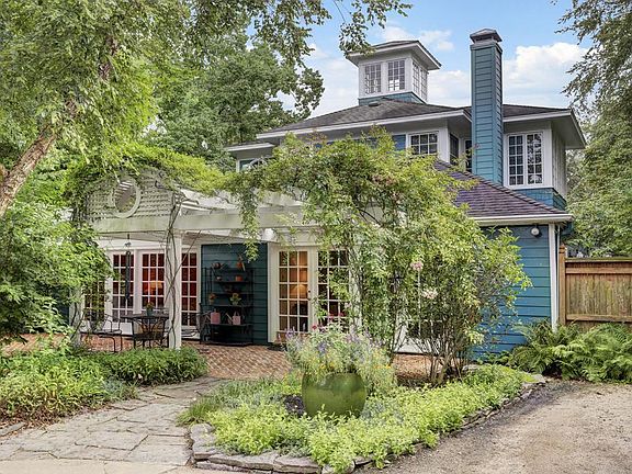 Rear view of home with pergola over brick patio. Hardi -plank exterior for low maintenance. Cupola p