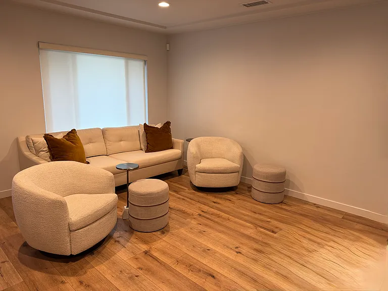Spacious living area with natural light and modern finishes. Furniture shown is for scale only and not included.