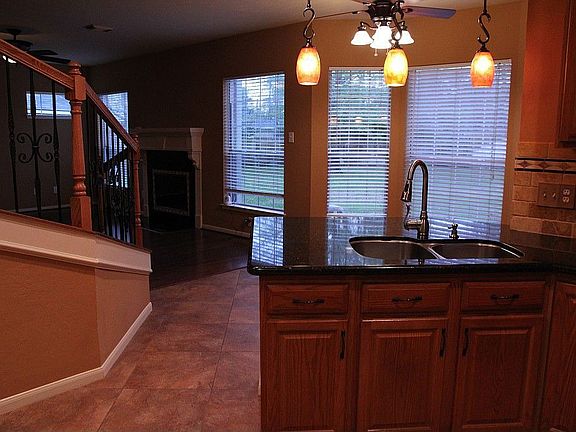 Granite kitchen, informal dining area overlooks backyard.