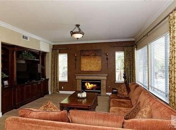 Sit down and relax in this lovely warm and inviting family roo with cozy fireplace and built-in medi