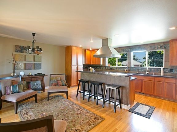 Gourmet kitchen with granite counters, tile back splash, stainless appliances with double drawer dishwasher, breakfast bar and plenty of room for a eat in kitchen table.