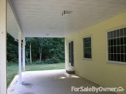 Private back porch
						:
						Covered porch stretches entire back of home.Wooded acreage plus sprinkler system