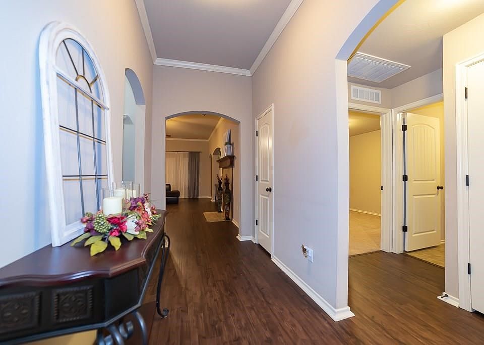Front entryway with elegant archway entry into living room