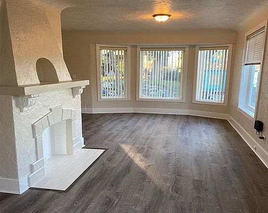 View of living room showing nice open floor plan, high coved ceilings and lots of natural light.
