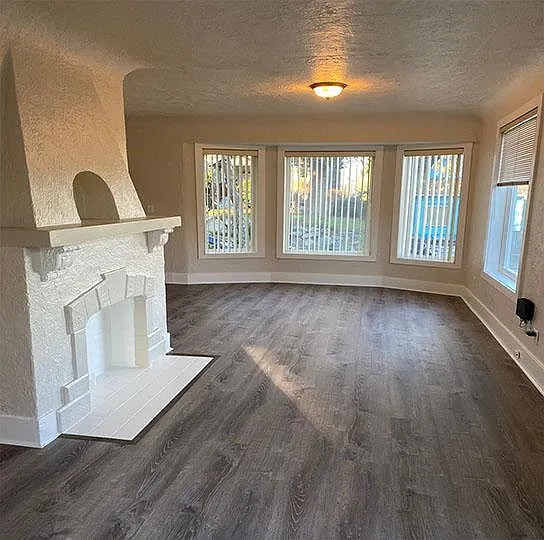 View of living room showing nice open floor plan, high coved ceilings and lots of natural light.