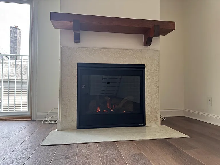 Modern gas fireplace with beautiful marbled surround.