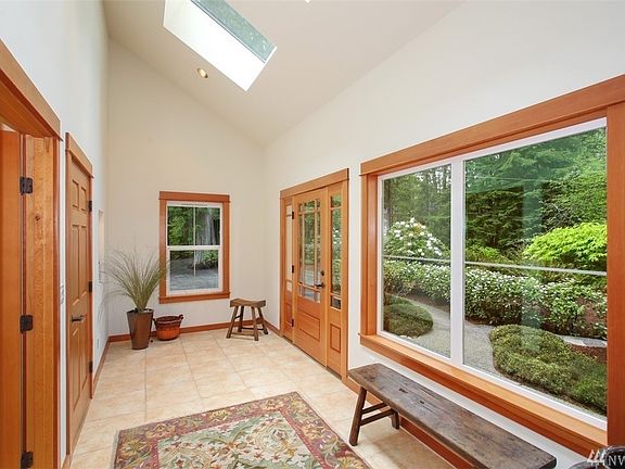 The foyer is flooded with light from the walls of windows and wonderful skylights!