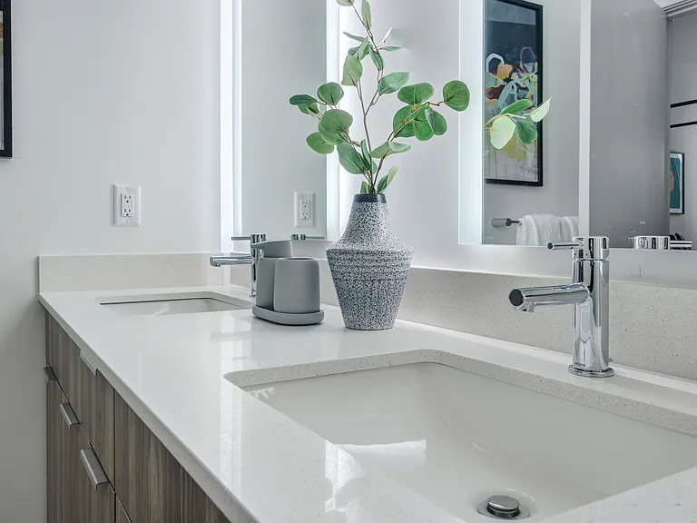 Serene bathrooms with frameless glass showers and floor-to-ceiling tile.