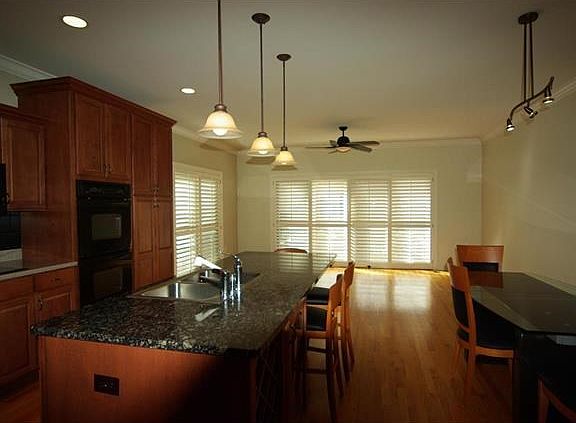 Kitchen with dining area and family area walk out to backyar