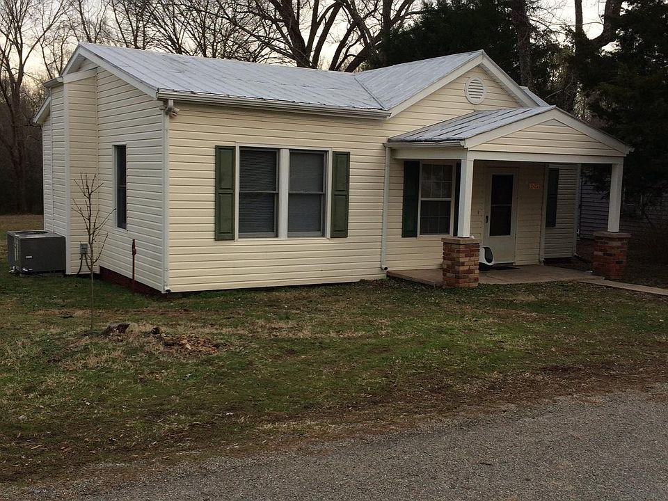 Tin roof, covered porch, vinyl siding