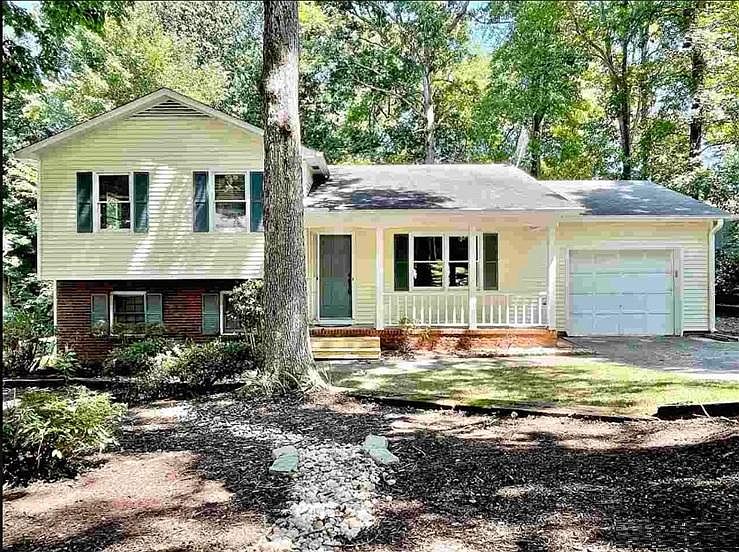 single family home (3 bedroom, 2.5 bath) with porch, garage and carport