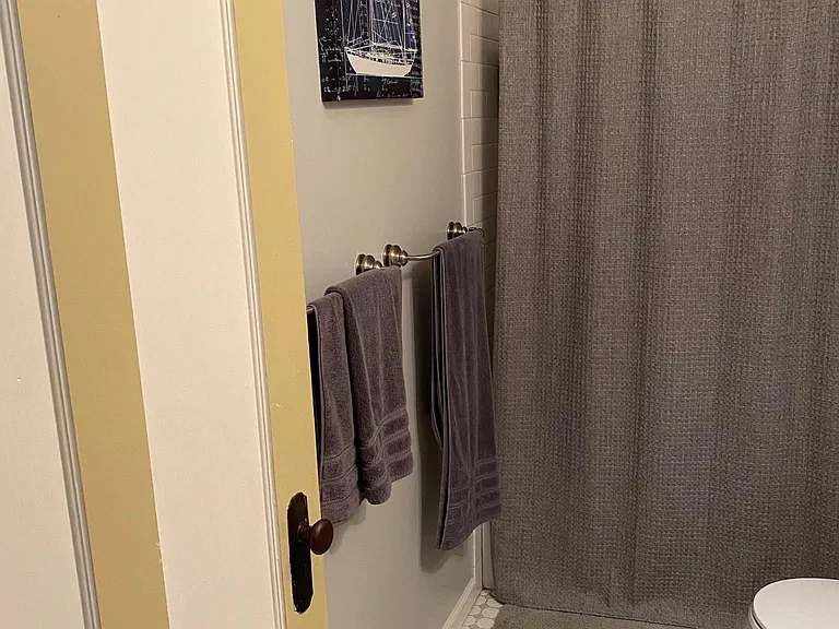 Bowed shower curtain rod for extra roomy shower space.