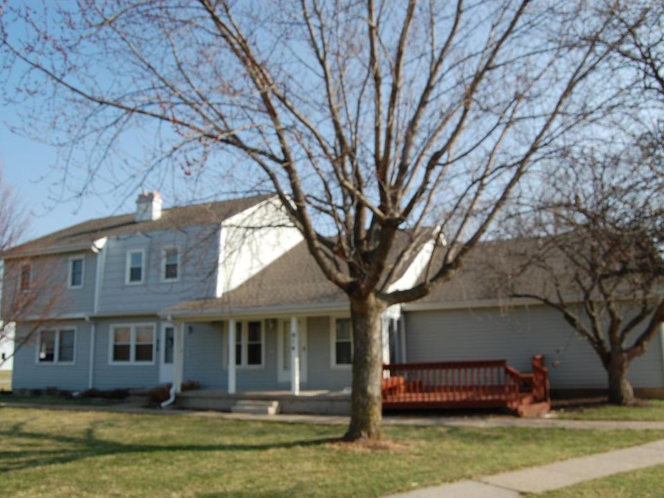 Front view, unit is identified by deck and front porch