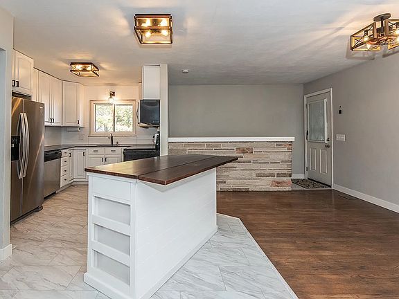 The Island is mobile and can be a bar top or that flap can be lowered.