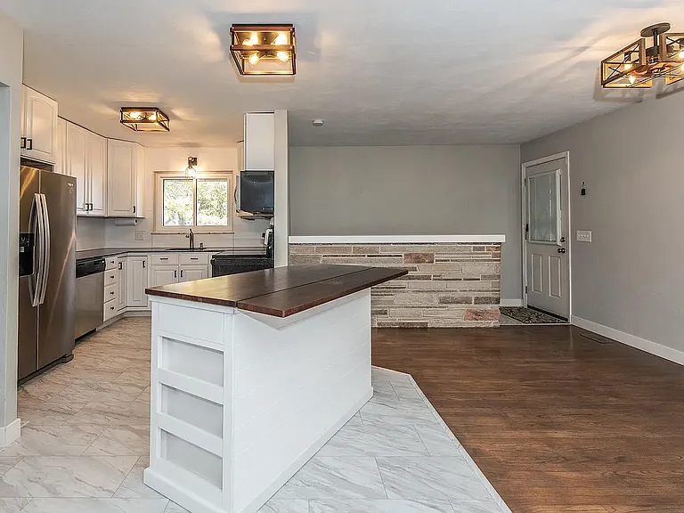 The Island is mobile and can be a bar top or that flap can be lowered.