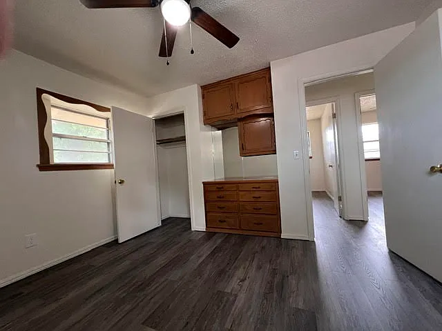 First bedroom with built in desk with half bath attached.