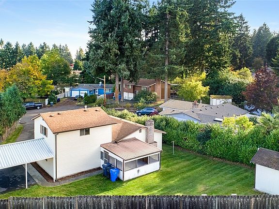 Sprawling backyard . Large screened porch and an outbuilding for all of your toys!