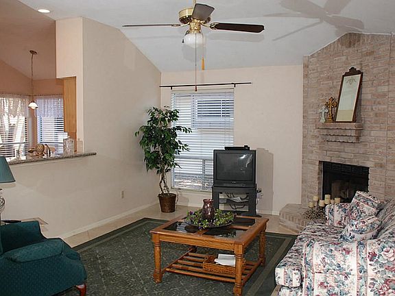 The family room is adjacent to the kitchen - it has a cozy corner fireplace & ceramic tile floors