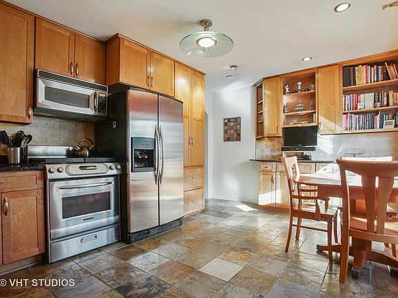 Kitchen has plenty of custom maple cabinets with pull outs and pantry. Beautiful granite counters and plenty of ceiling and under counter lights. Enjoy the Indian Autumn slate flooring- beautiful, strong but adds a warm touch.