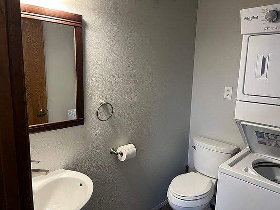 1/2 bath with stacking washer/dryer